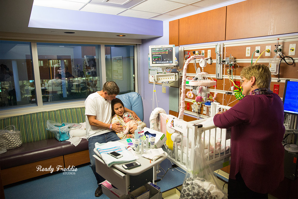 Parents hugging their NICU baby girl while being at Baptist South Miami Hospital