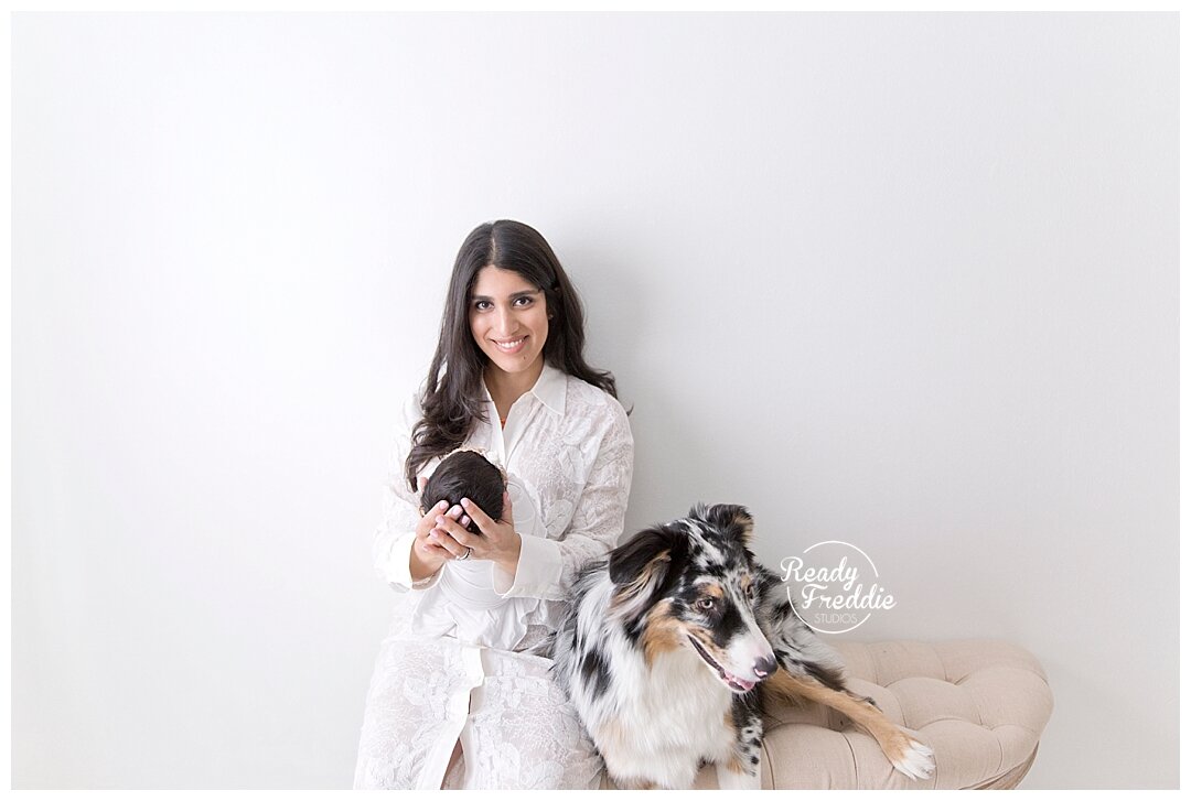 Mom with newborn daughter and puppy at Fort Lauderdale photography studio with Ivanna Vidal Photography