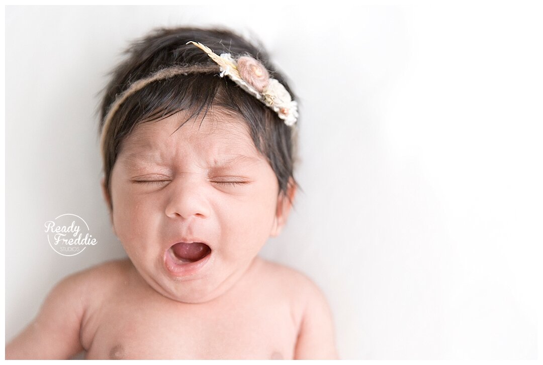 Baby yawns during newborn photography session by Ivanna Vidal Photography in Fort Lauderdale studio