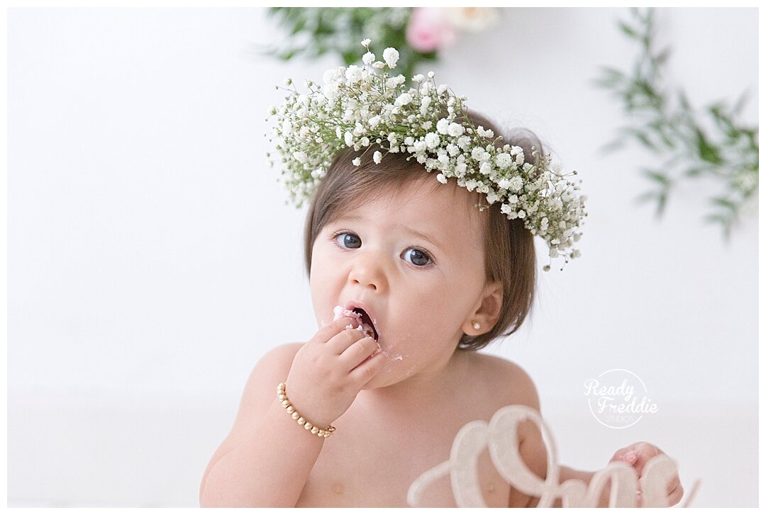 Indoor Cake Smash Session for girls filled with florals and baby breath by Miami photographer, Ivanna Vidal Photography