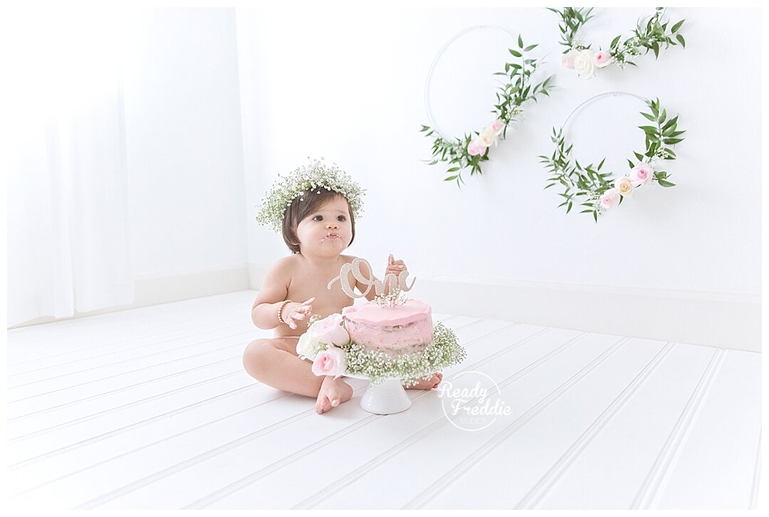 All white studio floral and pink cake smash session in Miami by Ivanna Vidal Photography