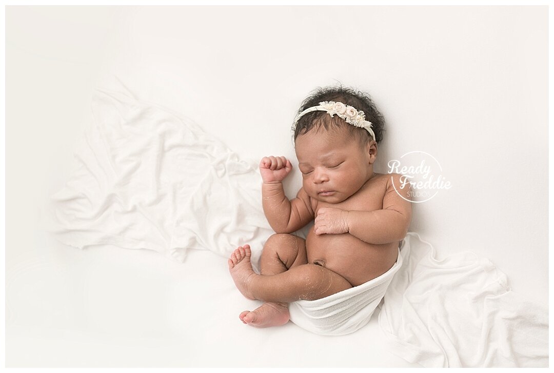 baby girl curling up during her newborn session in Miami with Ivanna Vidal Photography