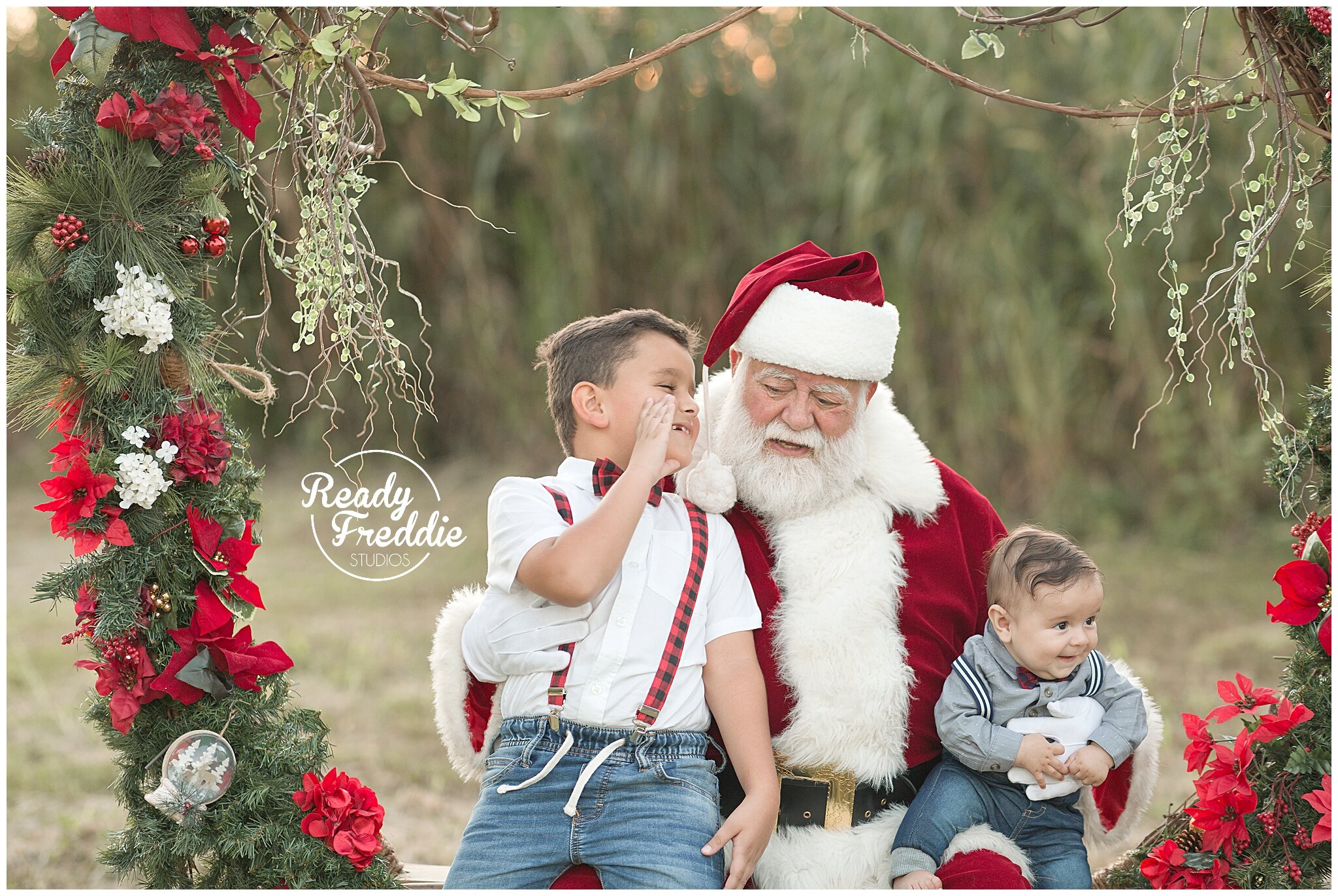 Sibling photos with Santa and giant wreath outdoor | Ready Freddie Studios Miami, FL