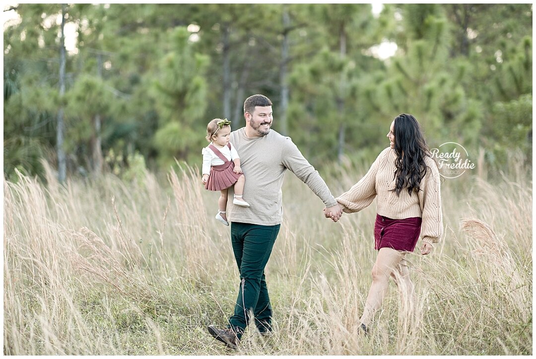 Family walking together smiling during their photography session | Ready Freddie Studios in Miami, FL