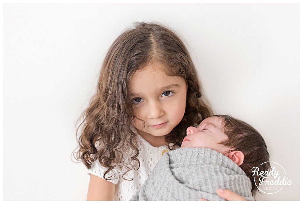 Sibling newborn photo with Doral family newborn photographer  | Ready Freddie Studios in Miami, FL