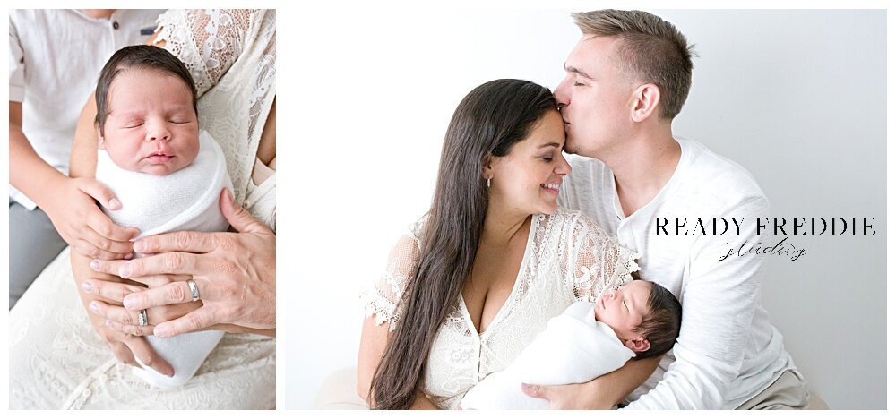 Mom holding newborn daddy kisses mommy forehead during newborn session | Ready Freddie Studios - Miami, FL