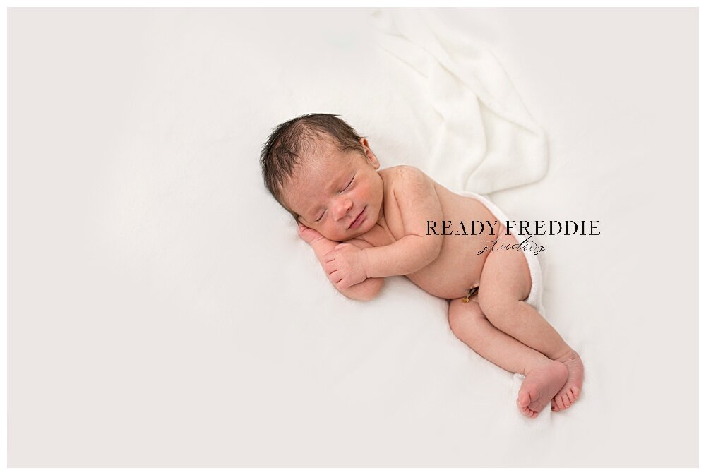 newborn poses in all white photography studio in Brickell Florida | Ready Freddie Studios - Miami, FL