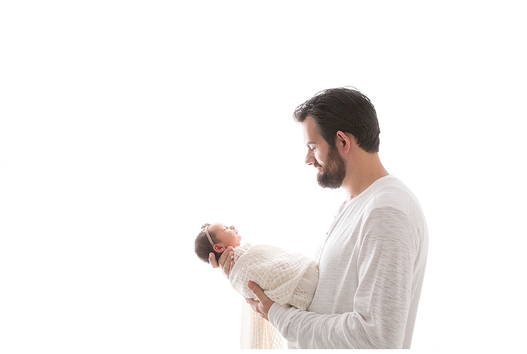 dad holding baby girl | newborn photographer in miami fl
