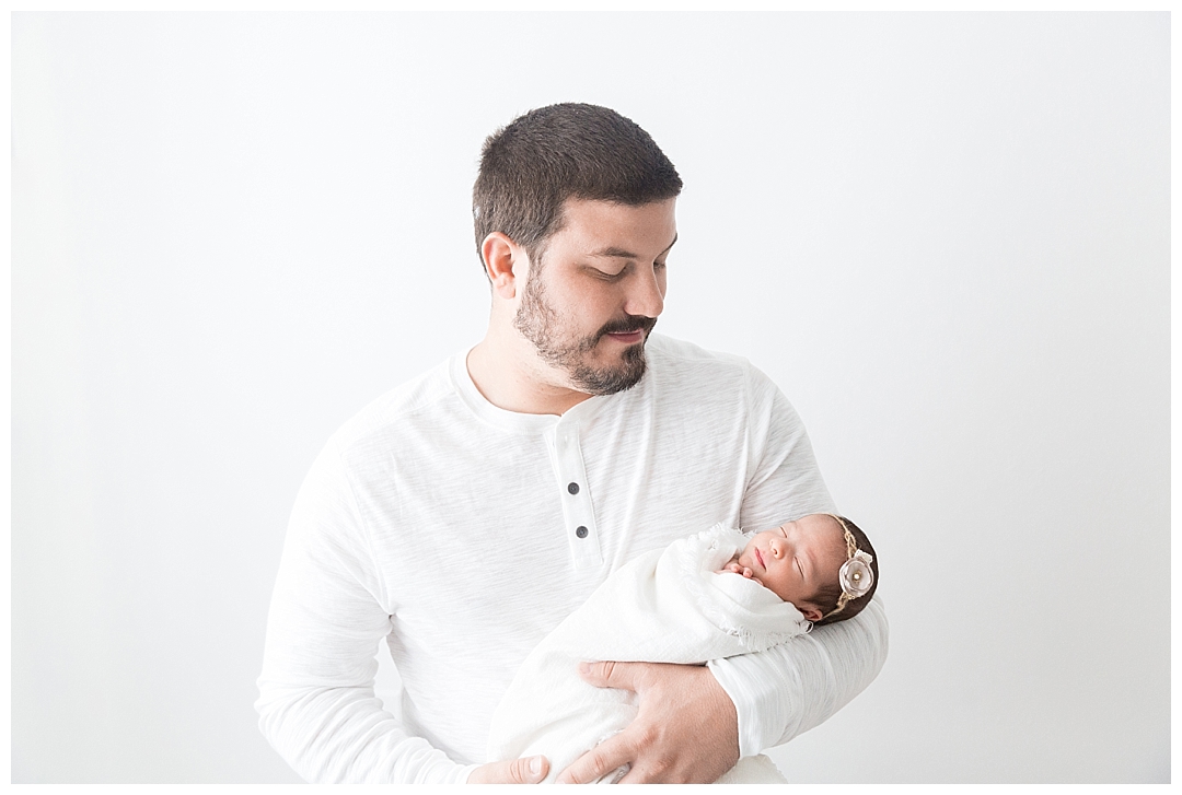 dad holding newborn baby | miami newborn photographer