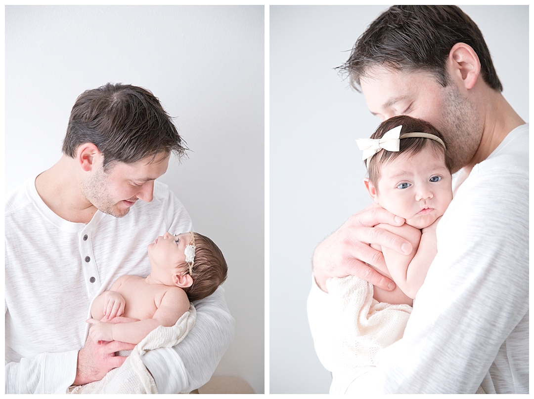 dad holding newborn baby girl | miami newborn photographers