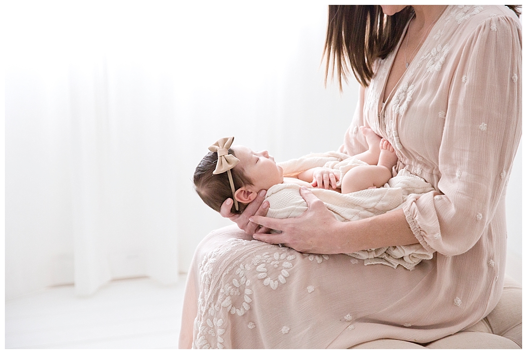 mom holding newborn baby | miami fl newborn photographer