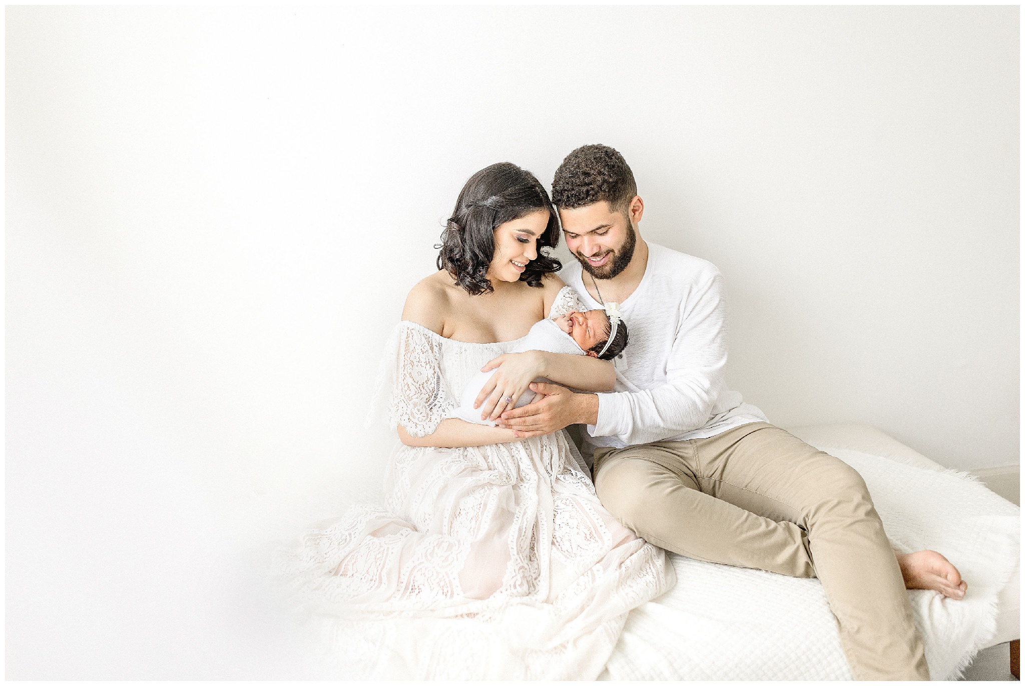Mom and dad cradle baby girl. Photo by Ivanna Vidal Photography.