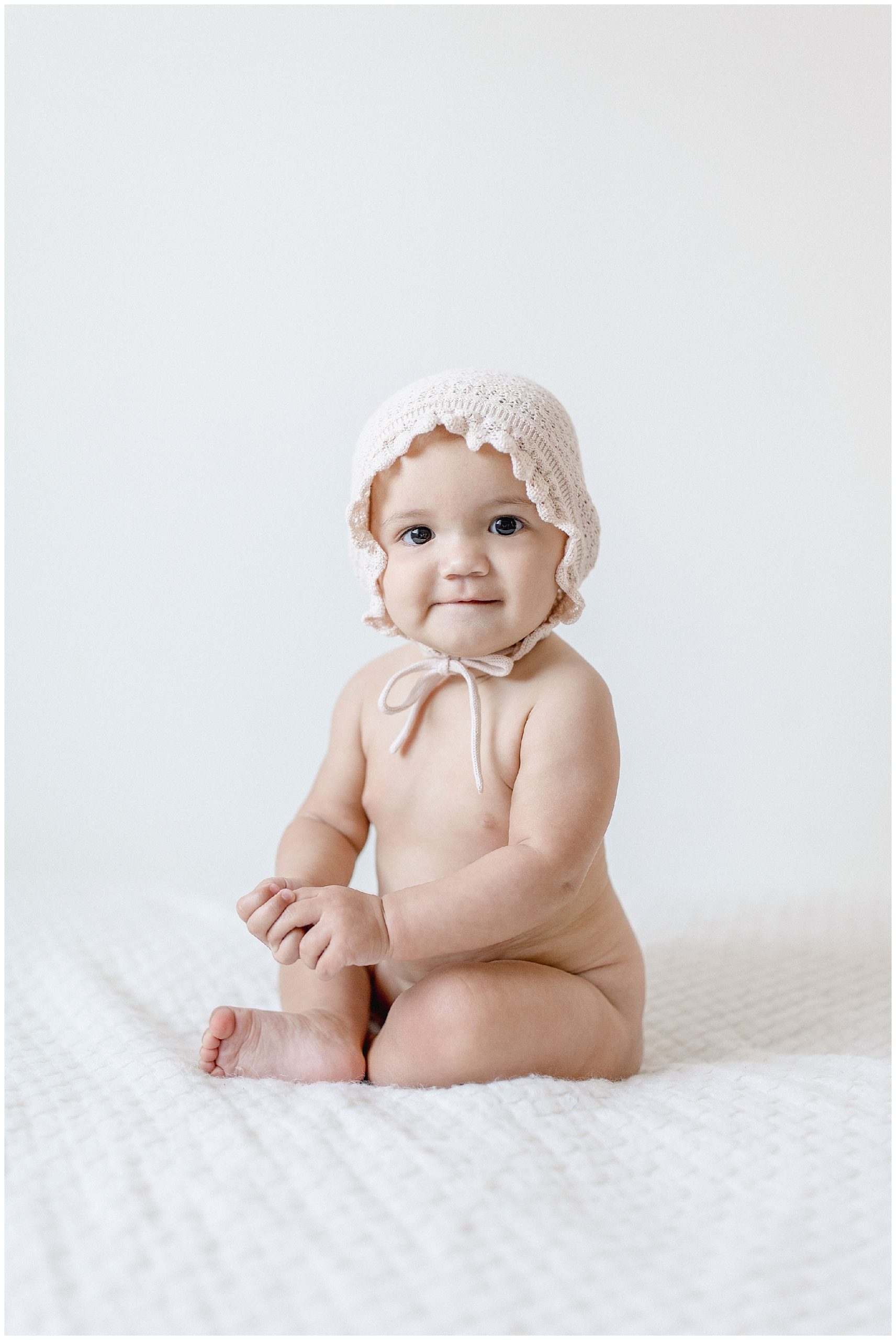 Baby girl in bonnet. Photos by Ivanna Vidal Photography.