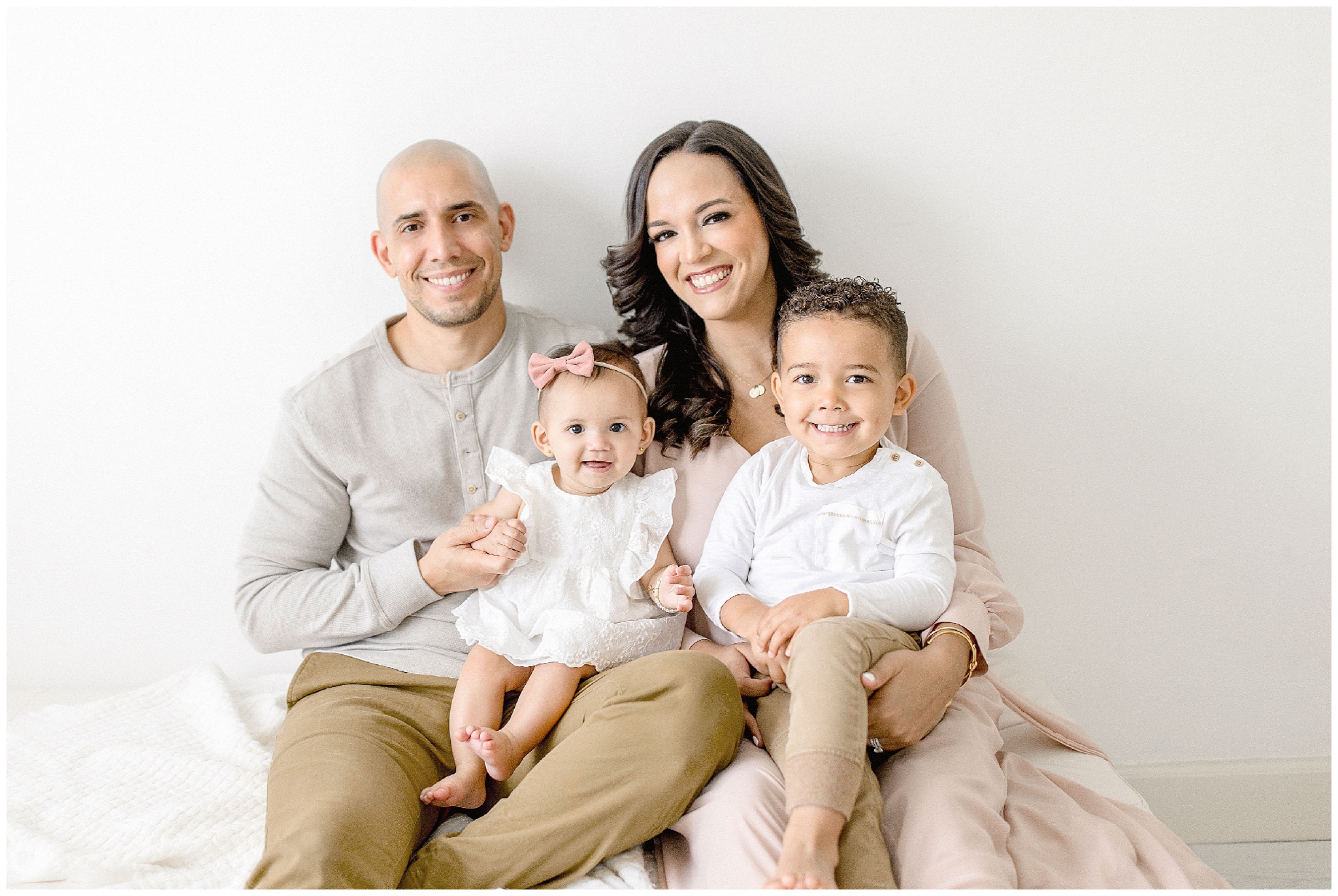 Family poses for portrait in Miami Studio. Photos by Ivanna Vidal Photography.