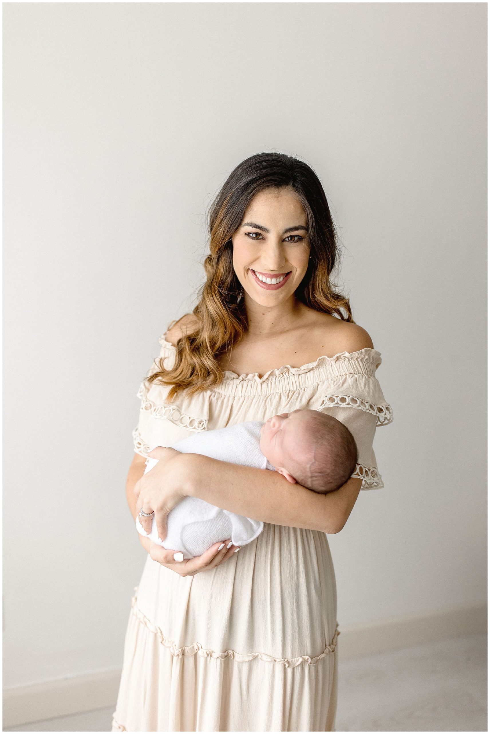 Mom holds her new son during South Florida newborn session. Photo by Ivanna Vidal Photography.