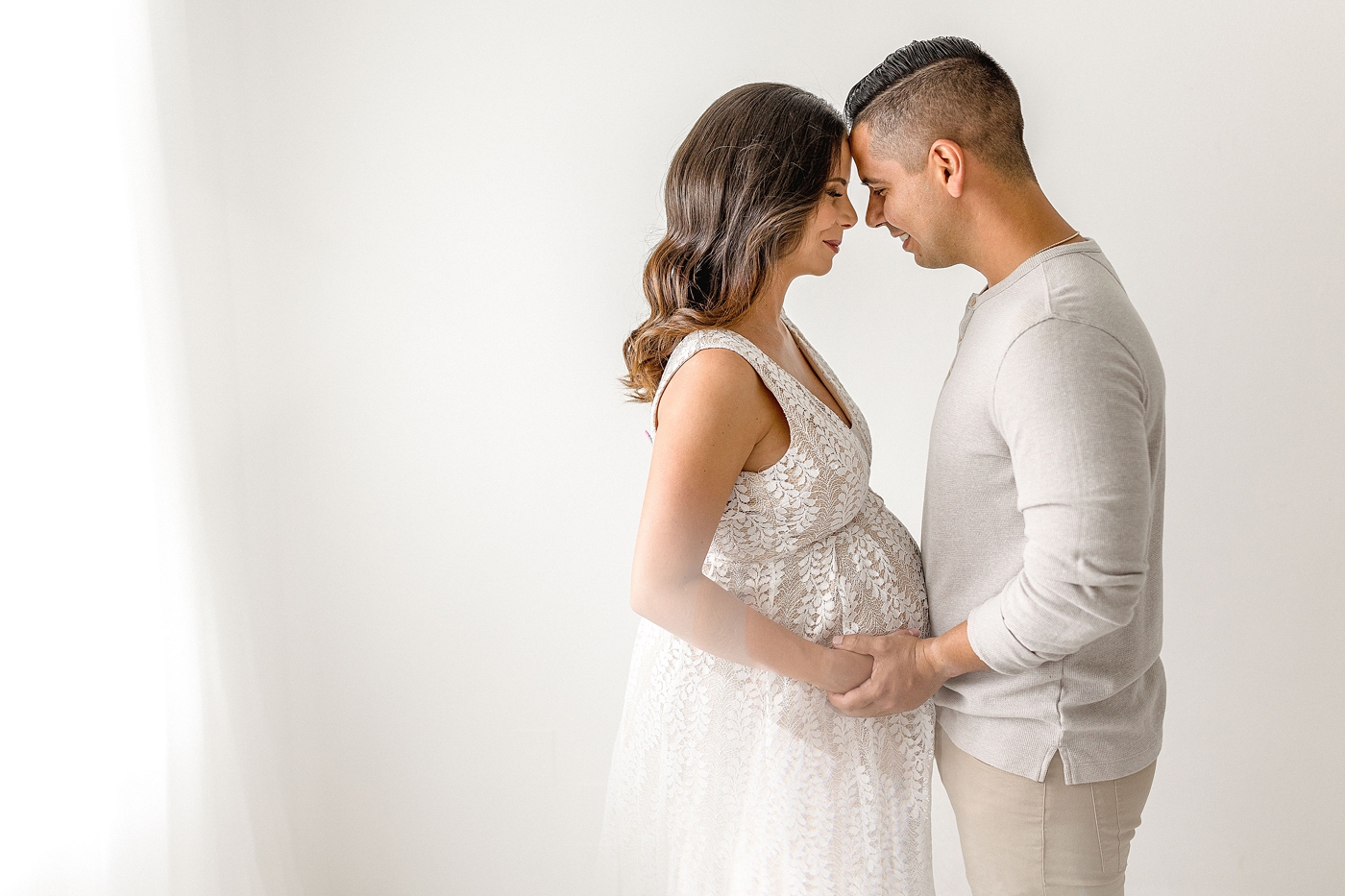 Mom and dad rest heads together during Miami maternity session. Photo by Ivanna Vidal Photography.