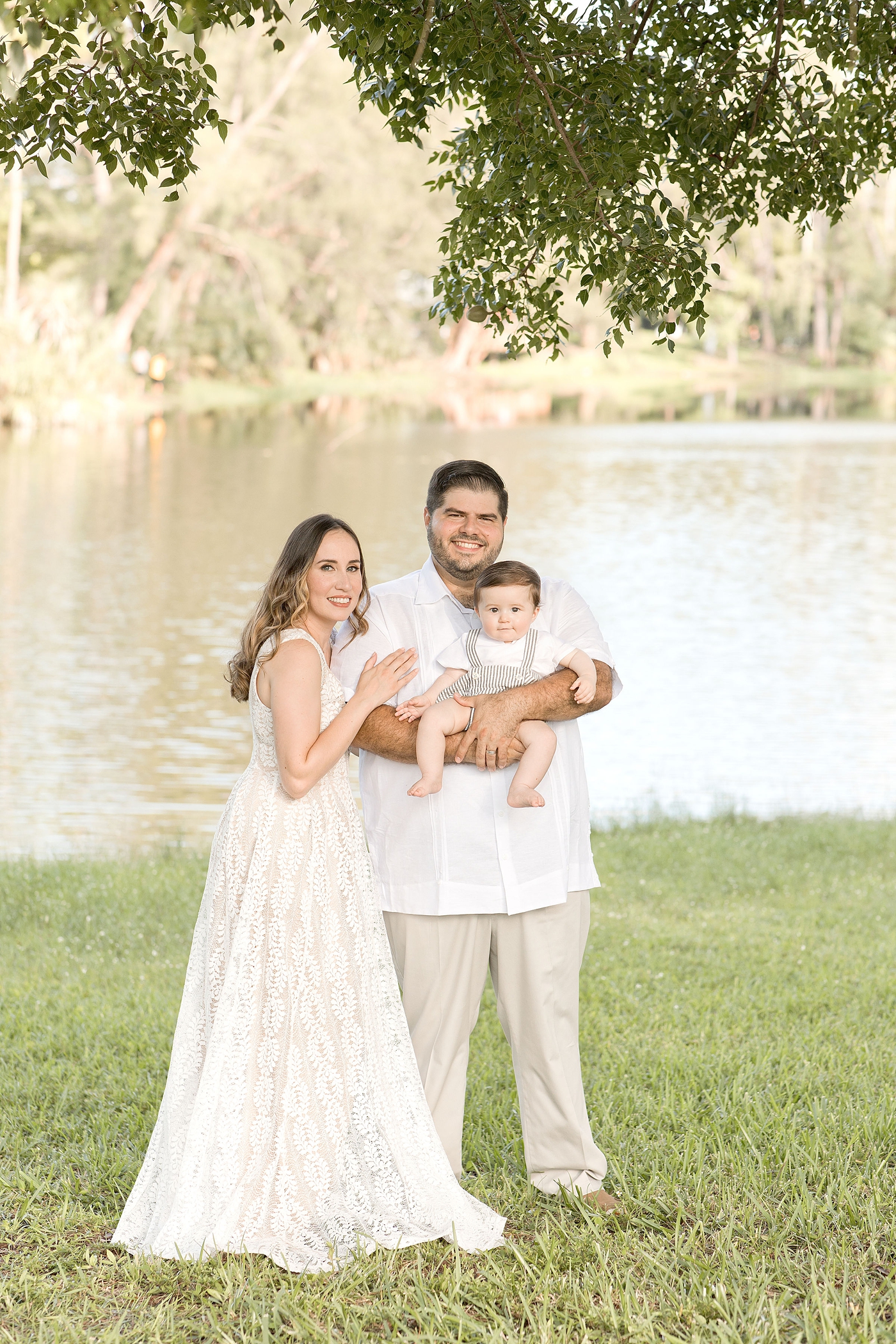 Family of three takes portrait by the water with Miami Children Photographer. Photo by Ivanna Vidal Photography.