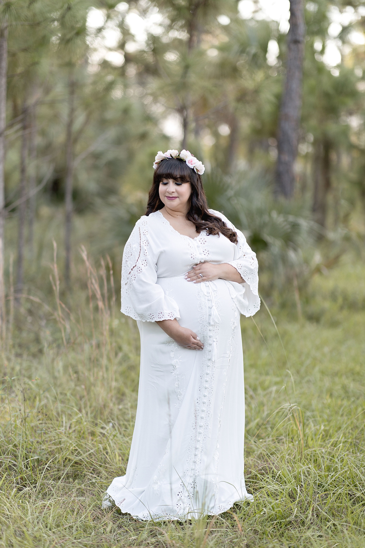 Mom to be embraces belly during mother nature inspired maternity session. Photo by South Florida Maternity Photographer Ivanna Vidal Photography.
