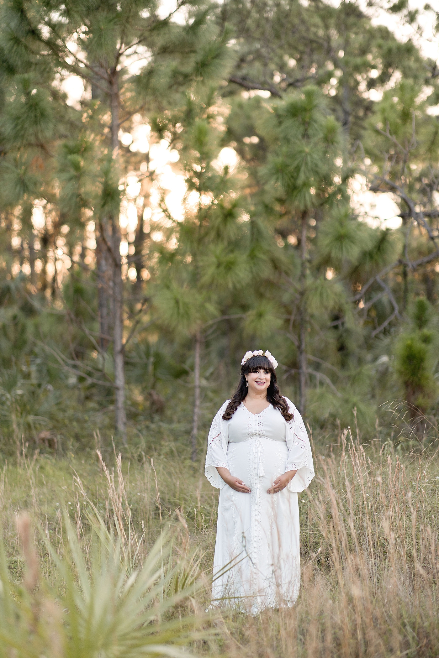 Mom to be stands in tall grasses in Miami by South Florida Maternity Photographer Ivanna Vidal Photography.