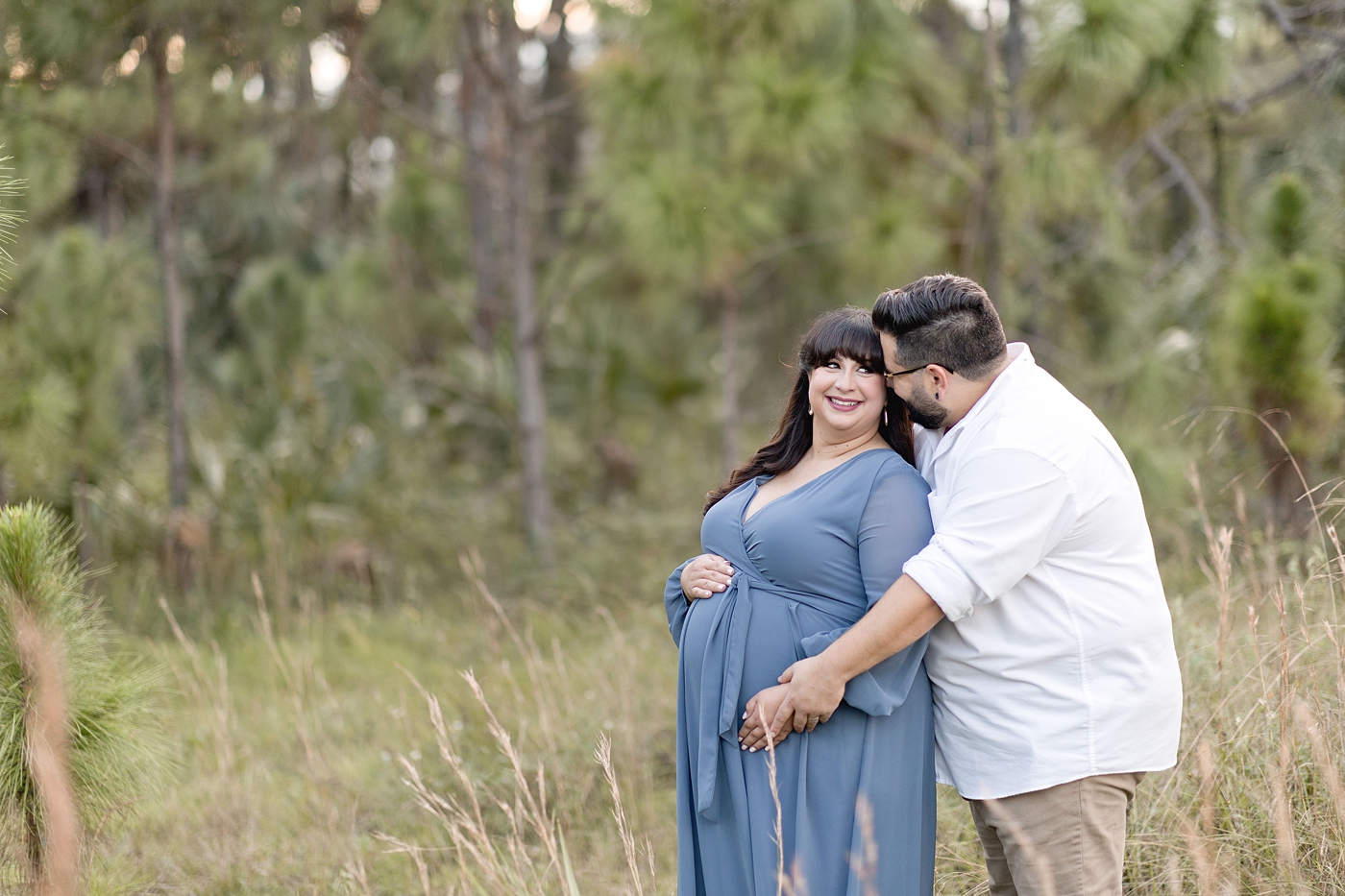 Mom and dad embrace during Miami maternity session. Photo by South Florida Maternity Photographer Ivanna Vidal Photography.