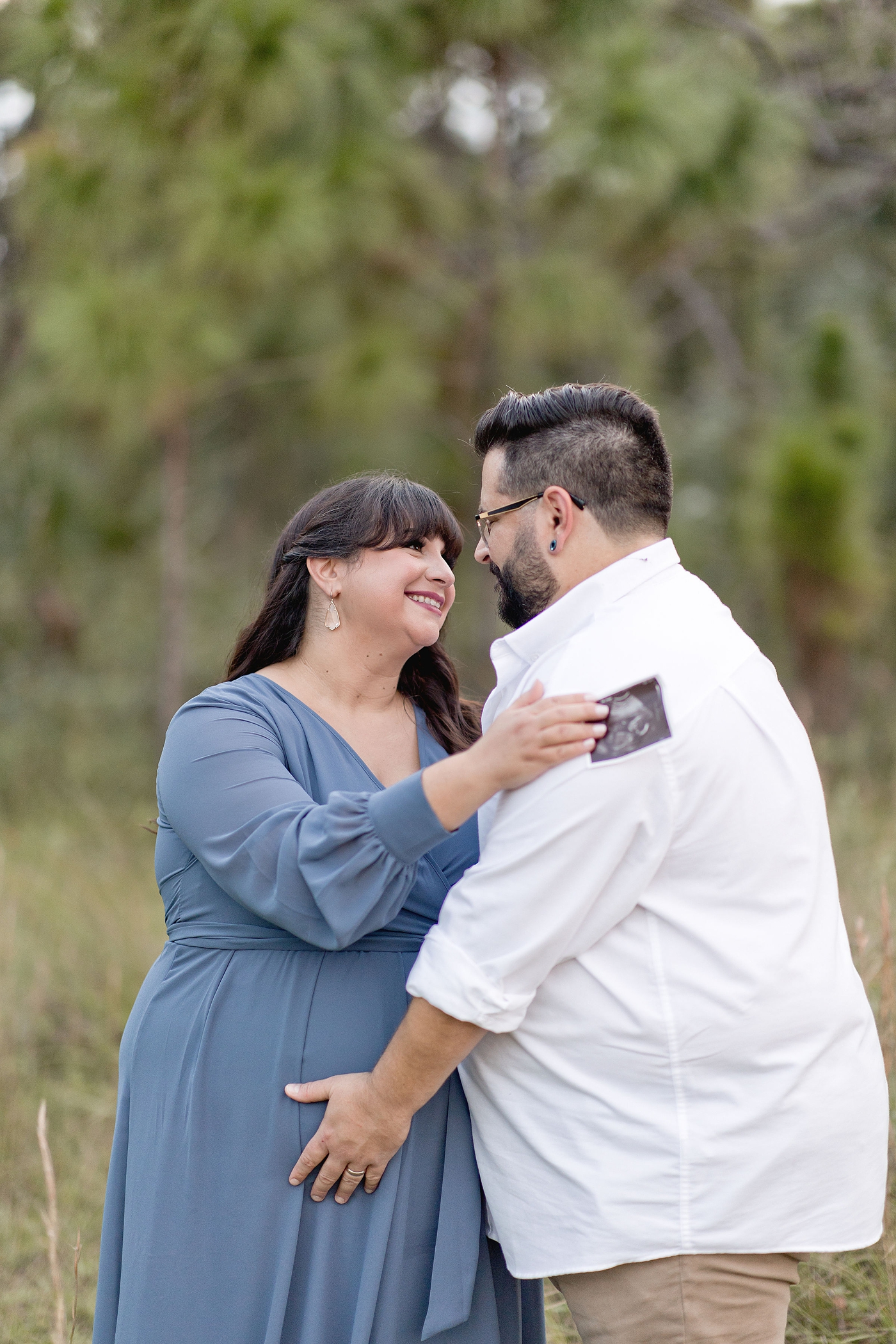 Mom holds ultrasound during mother nature inspired maternity session. Photo by Ivanna Vidal Photography.