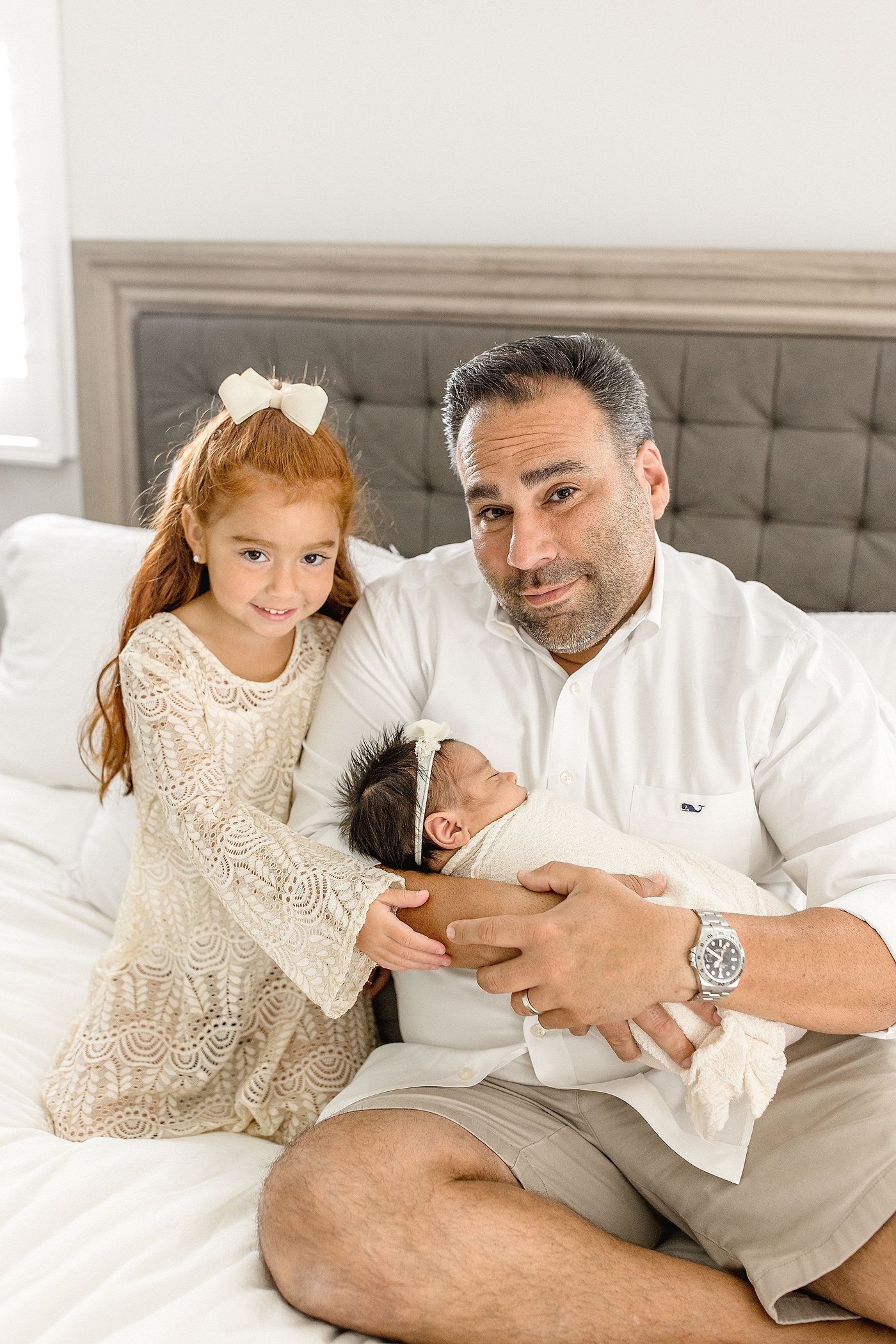 Dad and his two daughters during newborn photos. Photo by Ivanna Vidal Photography.