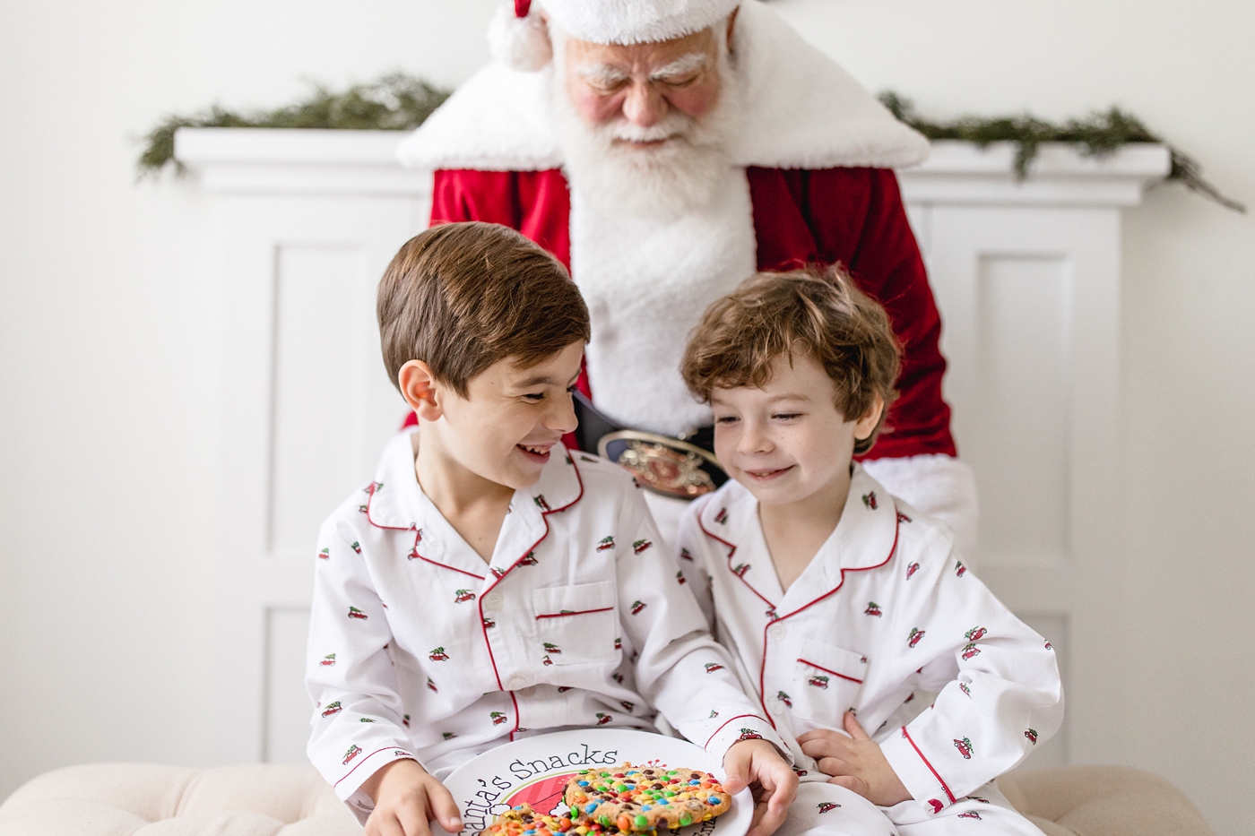 Little boys share a plate of cookies with Santa. Photo by Ivanna Vidal Photography.