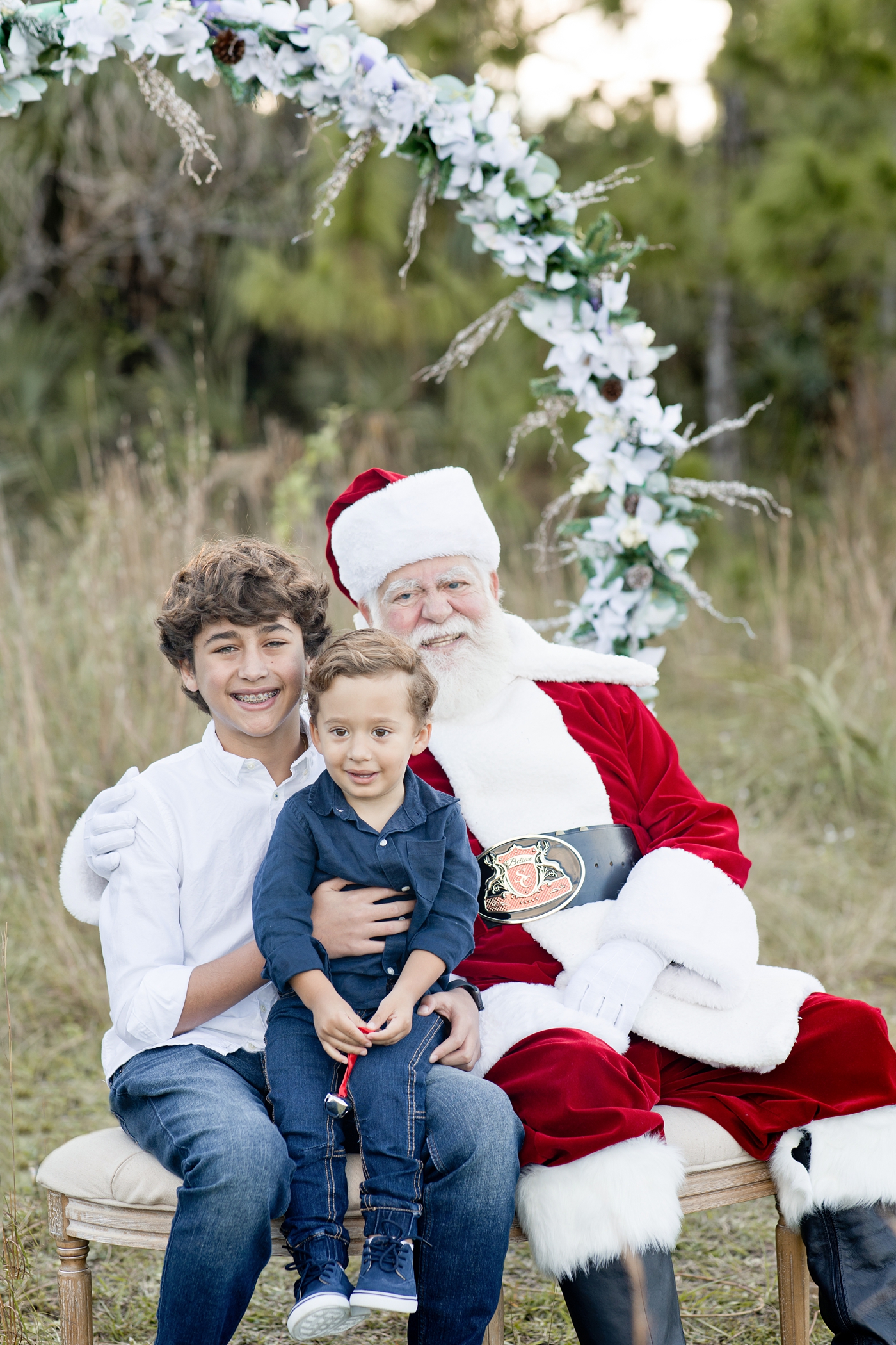 Brothers sit with Santa Clause in Miami. Photo by Ivanna Vidal Photography.