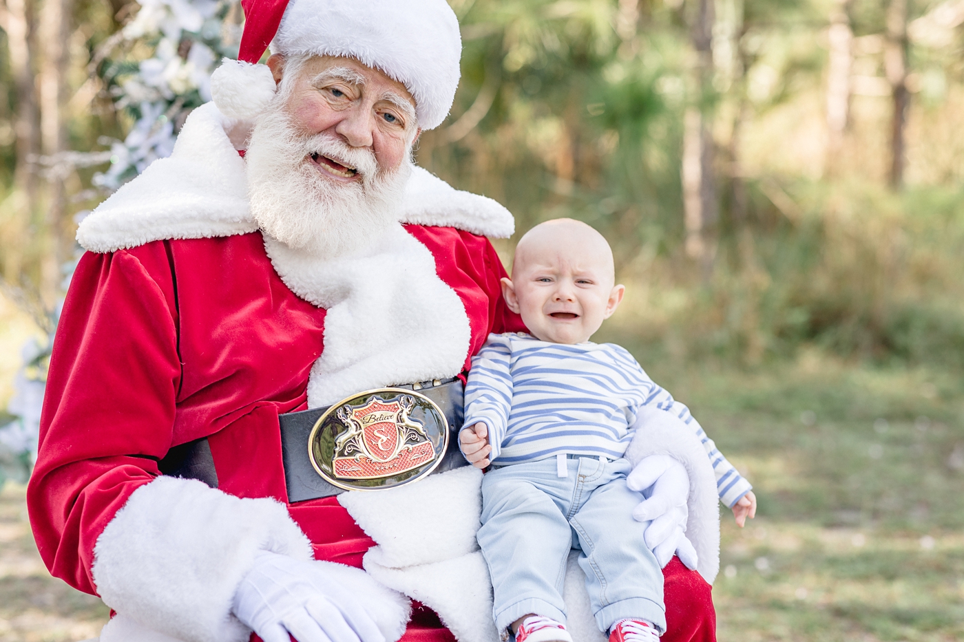 Baby boy is unsure of Santa Claus. Photo by Ivanna Vidal Photography.