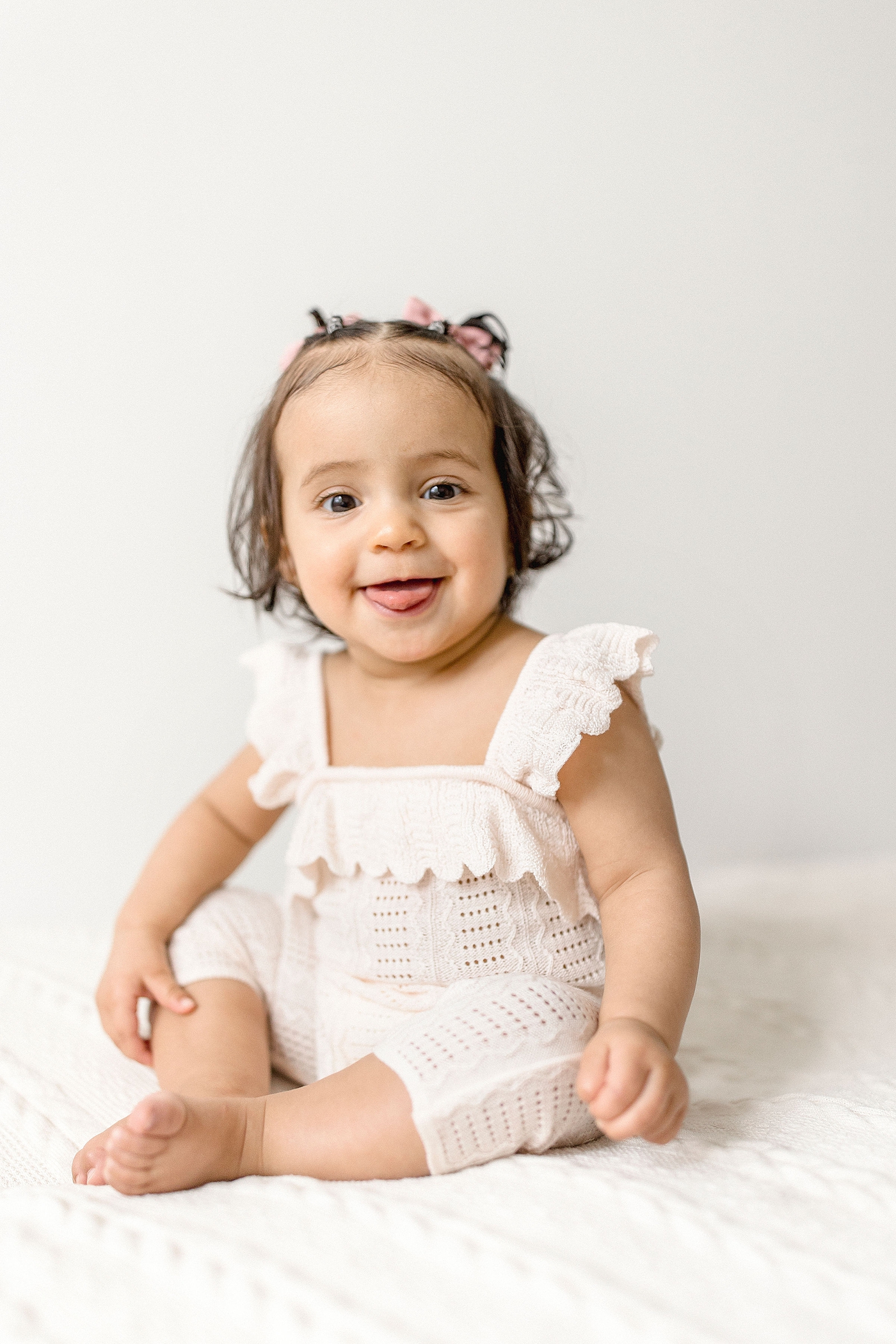 Baby girl smiles big for her portrait during her baby photography miami session. Photo by Ivanna Vidal Photography.