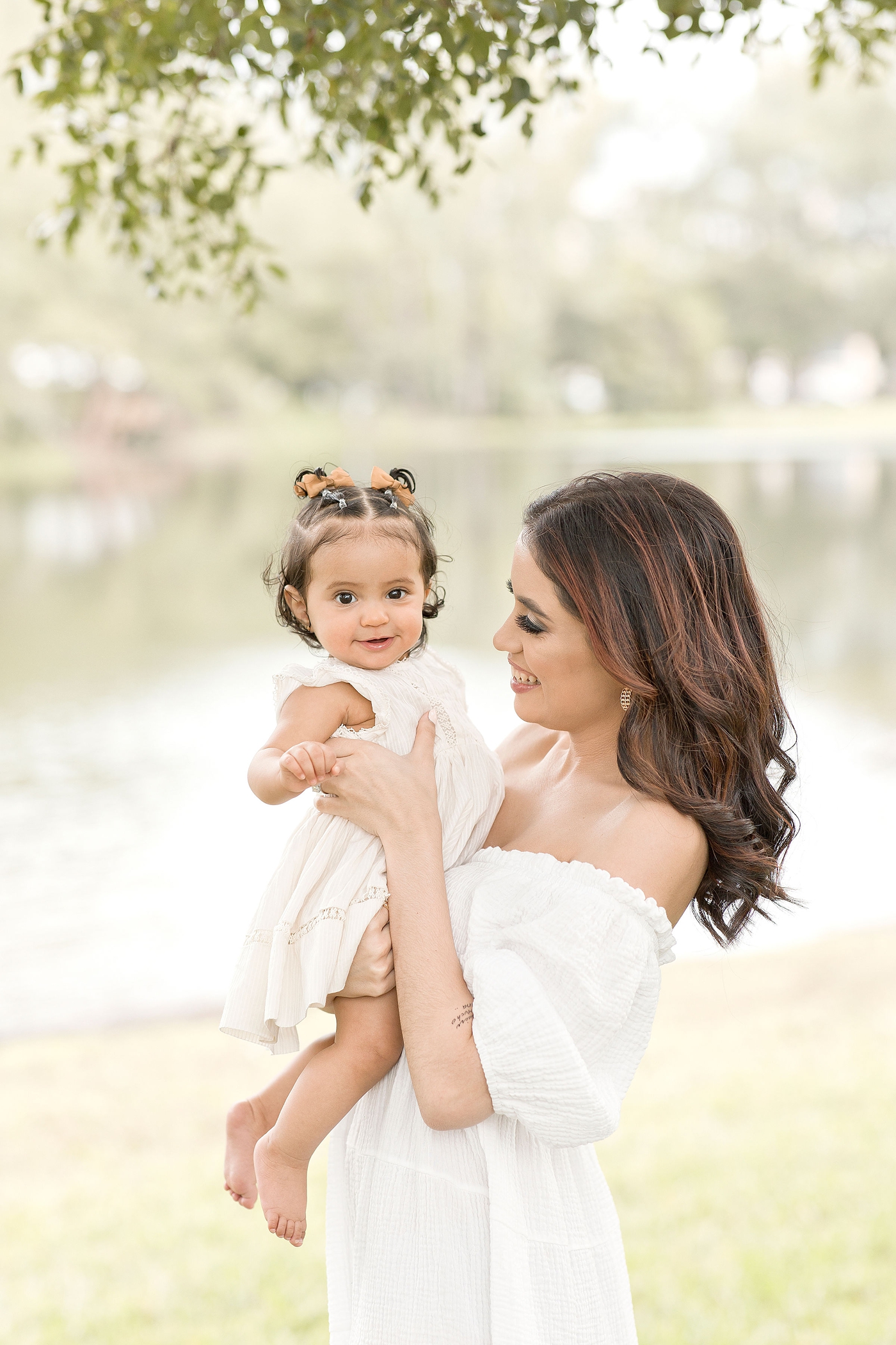 Mom holds up baby girl during baby photography miami session. Photo by Ivanna Vidal Photography.