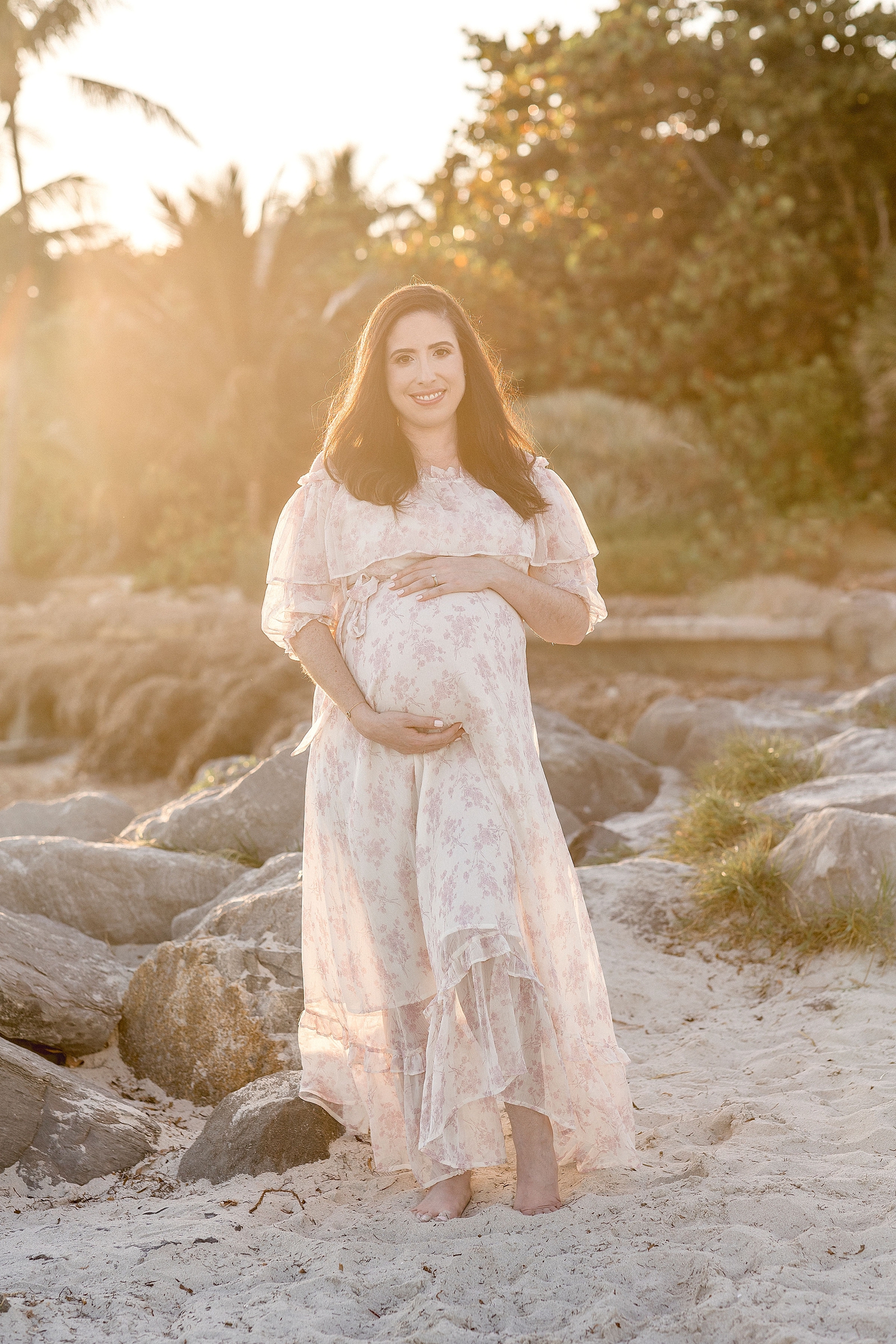 Mom to be stuns in golden light during maternity session at El Farito Beach Miami FL. Photo by Ivanna Vidal Photography.