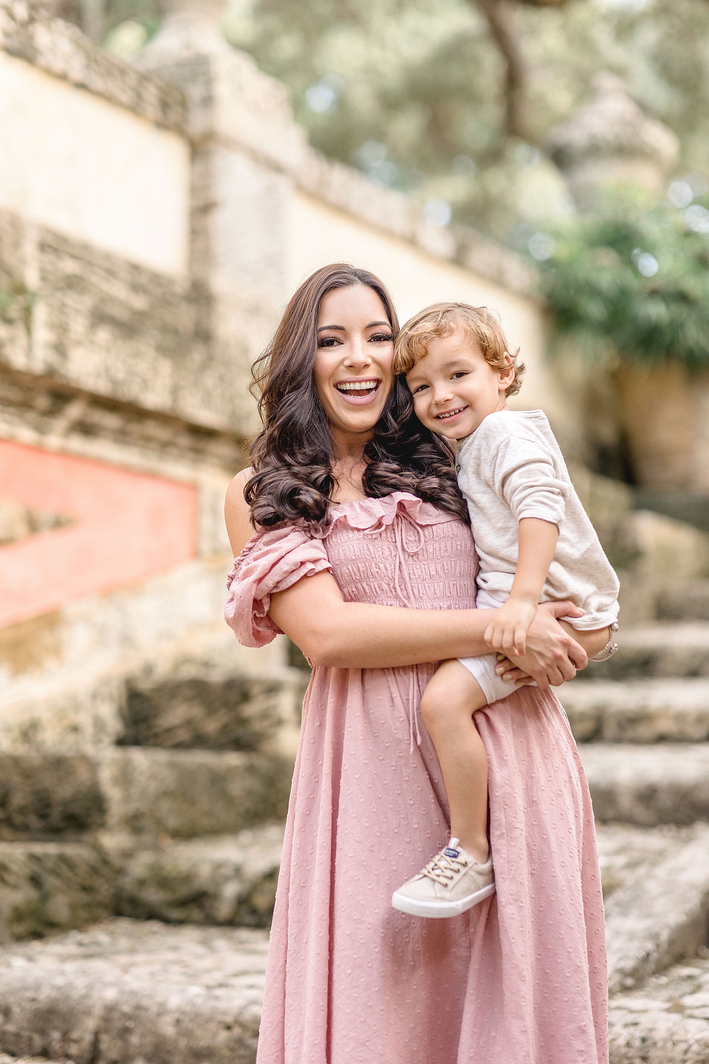 Mom holds young son on steps of Vizcaya museum. Images by Ivanna Vidal Photography.
