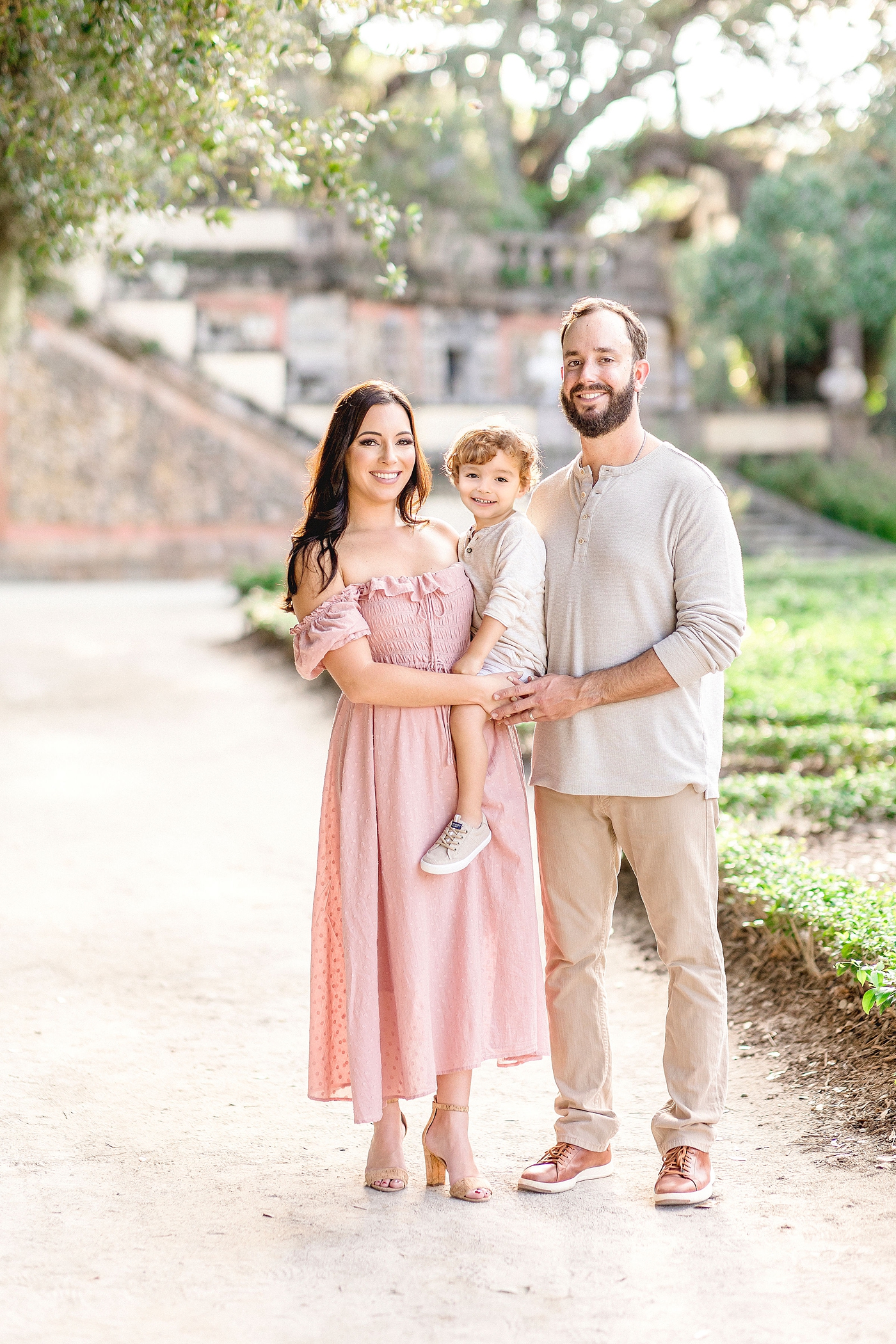 Beautiful smiling family portrait at Vizcaya Museum and Gardens in Miami. Photo by Ivanna Vidal Photography.
