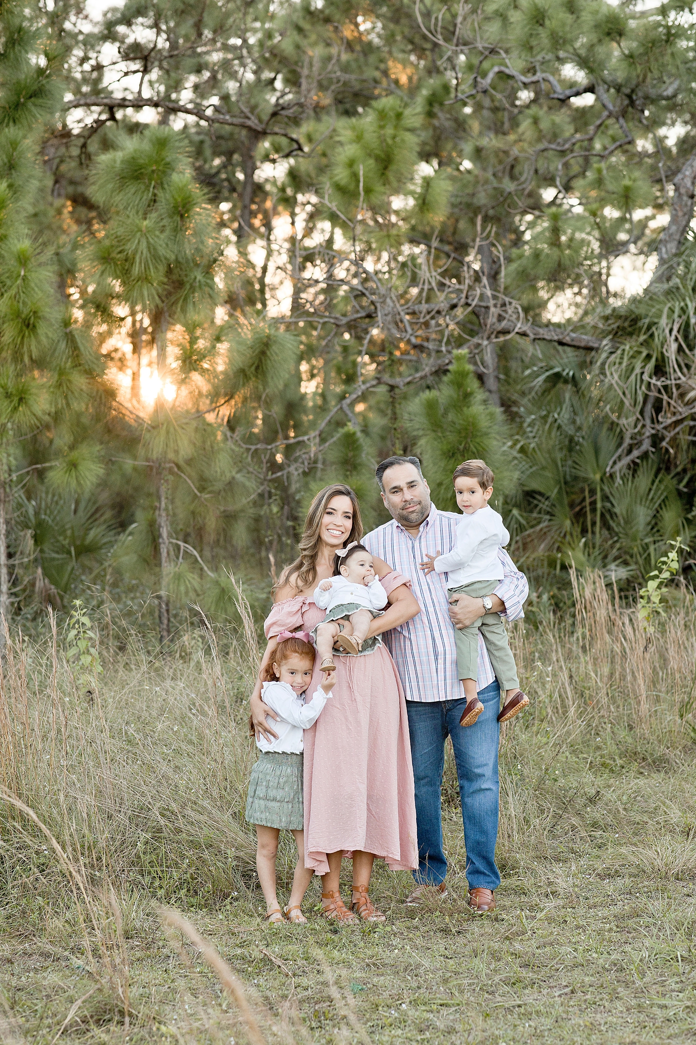 Family of five photographed in Miami field. Photo by Ivanna Vidal Photography.