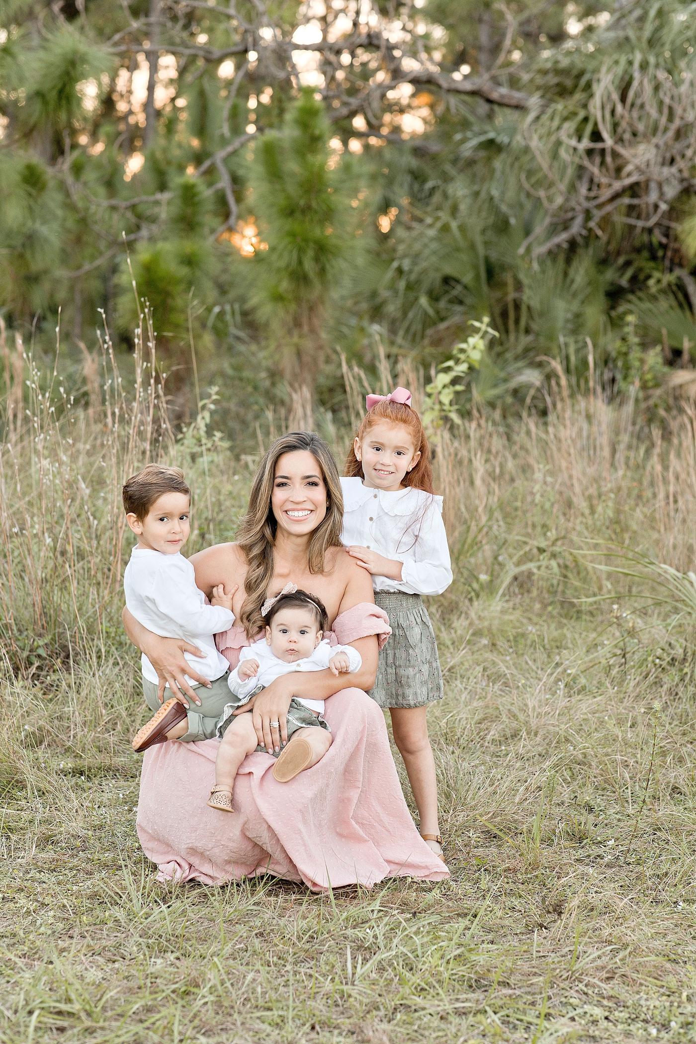 Mother takes portrait with her three children during Miami family session. Photo by Ivanna Vidal Photography.