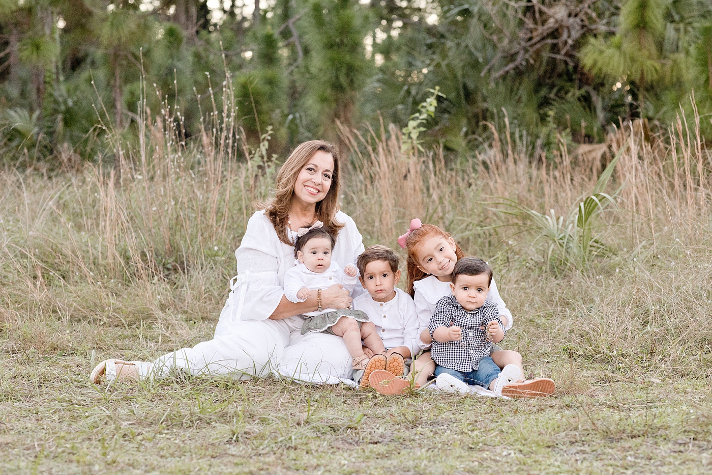 Grandmother sits with grandchildren during Miami family session. Photo by Ivanna Vidal Photography.