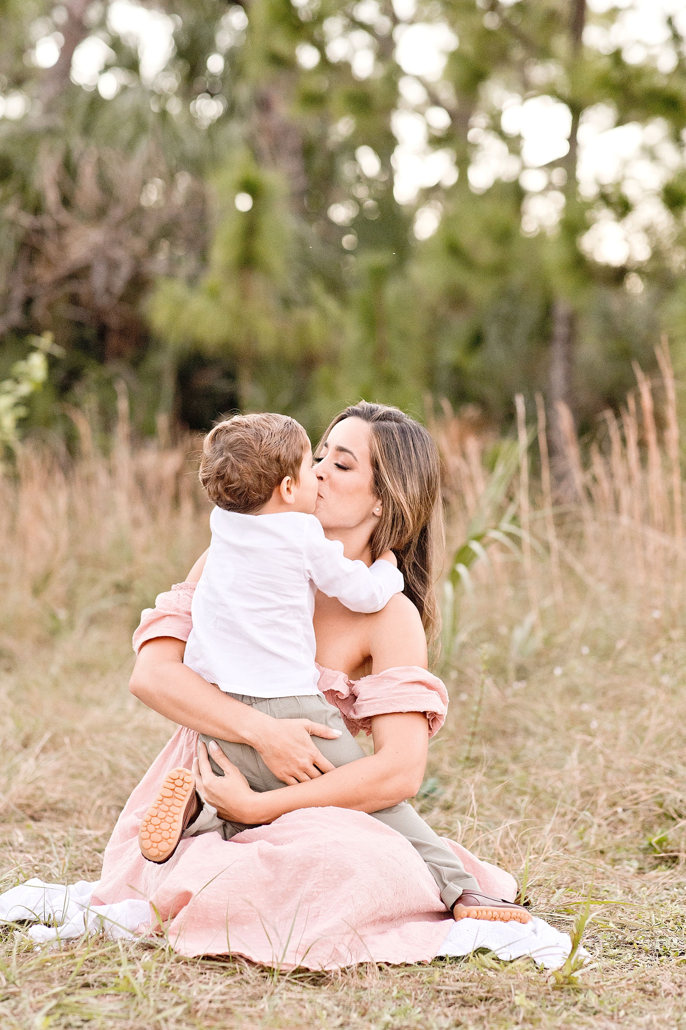 Mom kisses son during Miami photo session. Photo by Ivanna Vidal Photography.