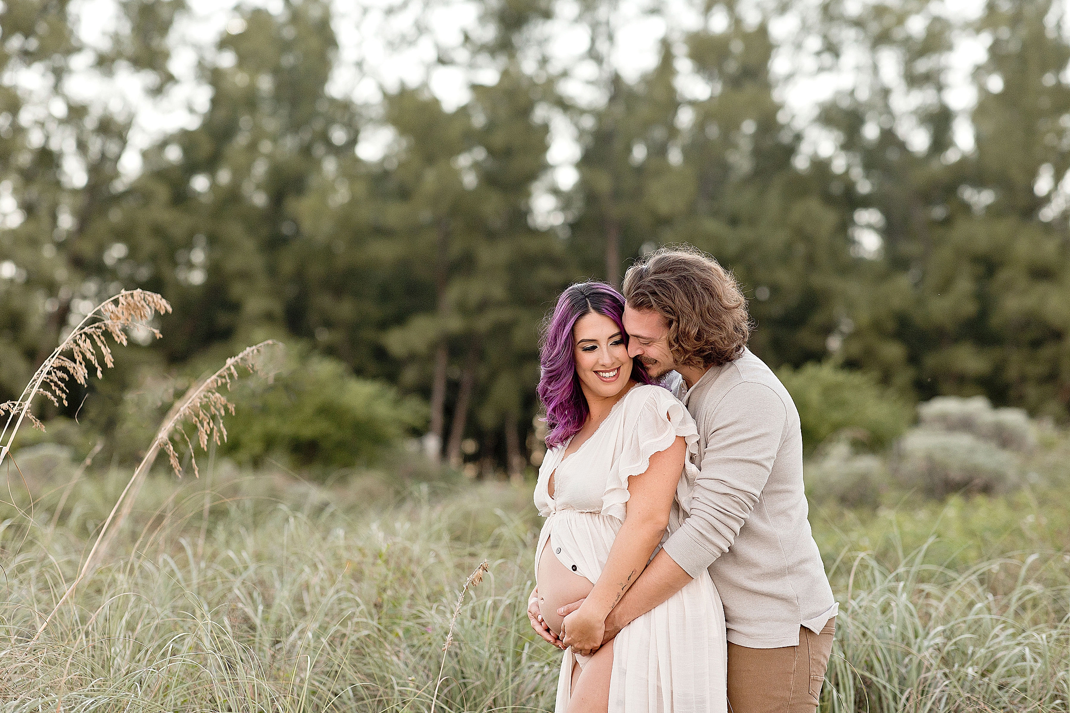 couple hugging each other after prenatal yoga in miami during their maternity session with Ivanna Vidal Photoraphy