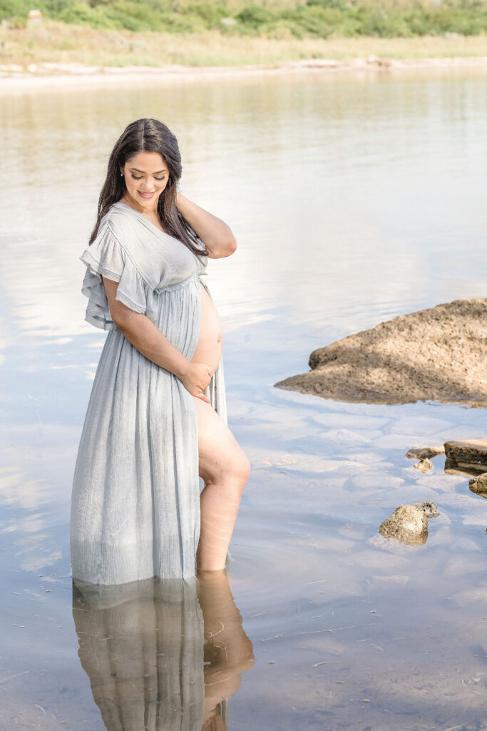 mom to be in the water at Virginia Key maternity photoshoot locations in miami