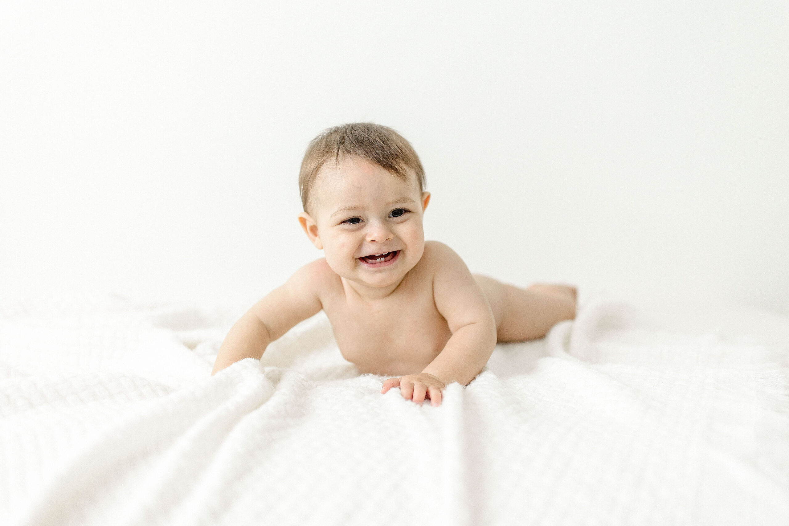 baby laying naked on a white sheet Hollywood Birth Center