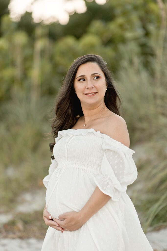 mom to be in white off the shoulder maternity gown Miami water birth
