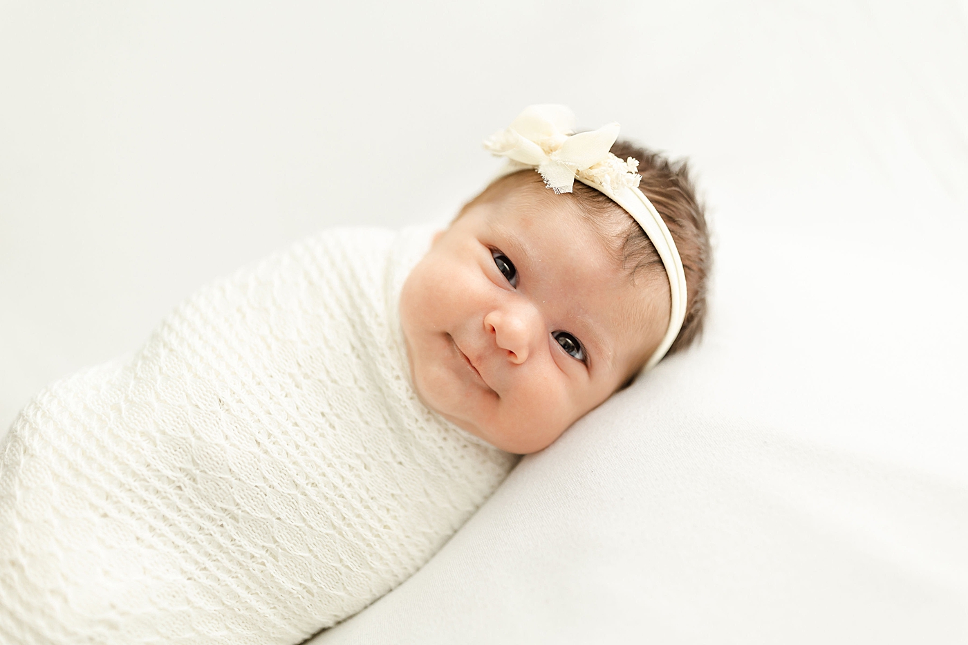 baby girl swaddled during her newborn session