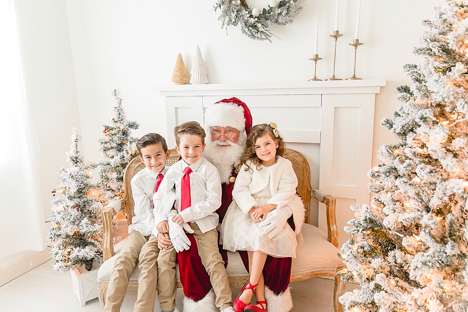 3 kids sitting on santas lap smiling | Ivanna Vidal Photography Santa Photos