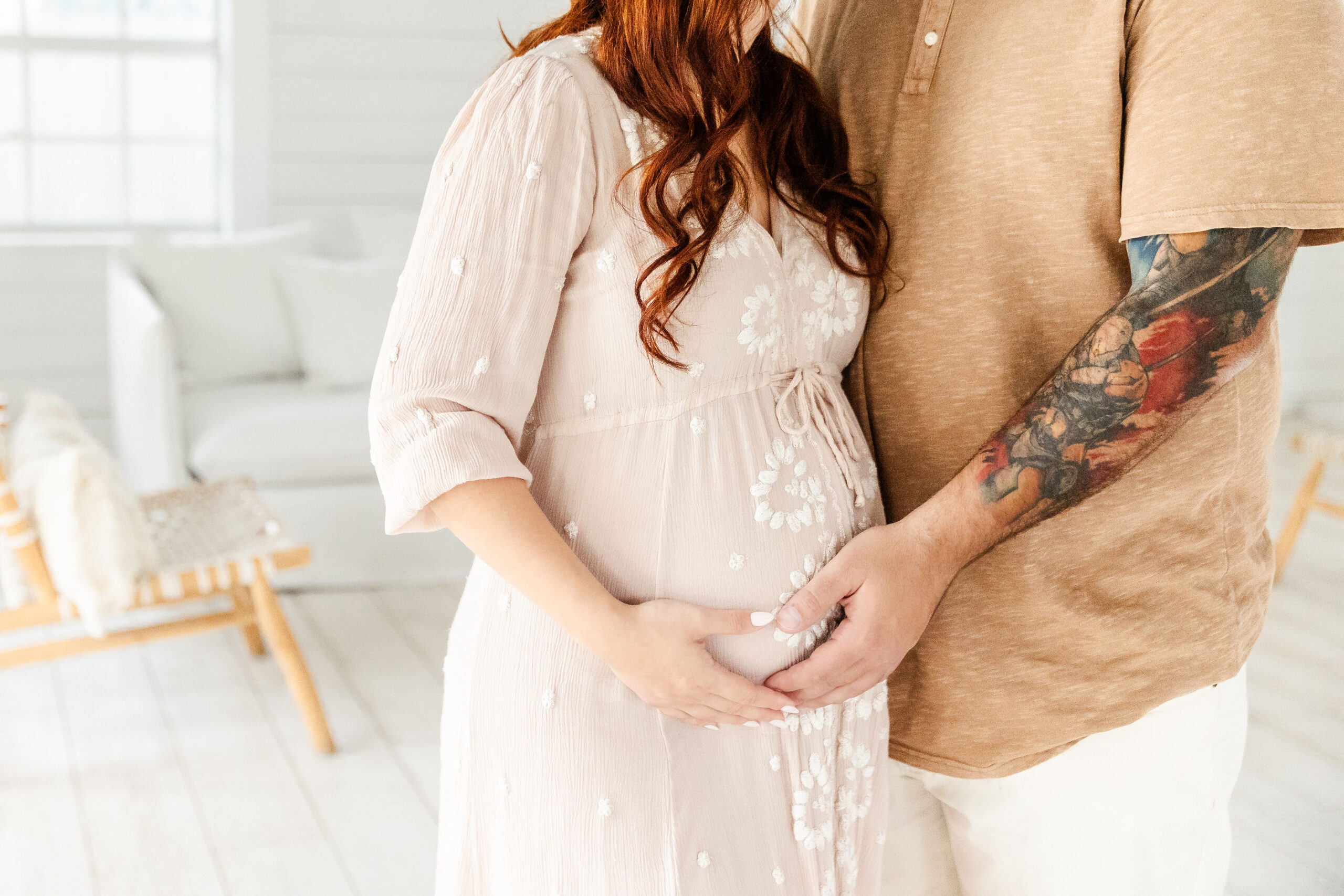 Details of an expecting standing in a studio holding the bump after a 3d ultrasound in fort lauderdale